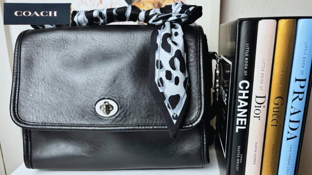 Woman carrying restored Coach Court Bag with perfect patina and turn-lock hardware