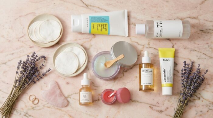 K-beauty skincare products including a jar of hydrogel masks on marble.